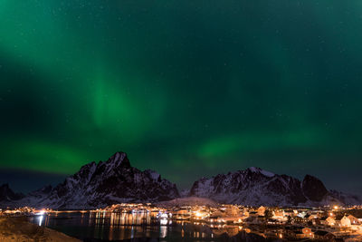 Scenic view of illuminated mountains against sky at night