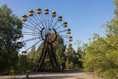 Low angle view of ferris wheel against sky