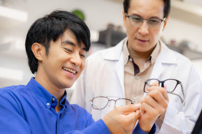 Smiling female doctor examining patient in hospital