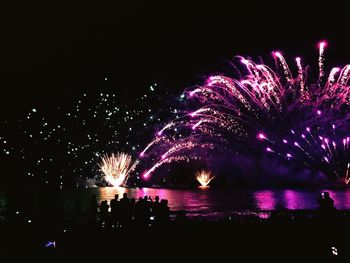 Low angle view of firework display at night