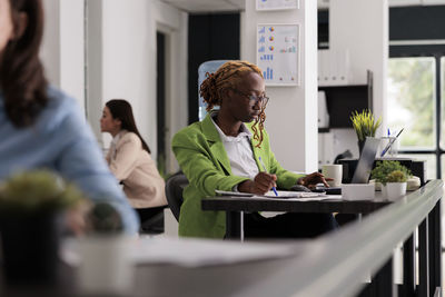 Side view of business colleagues working in office