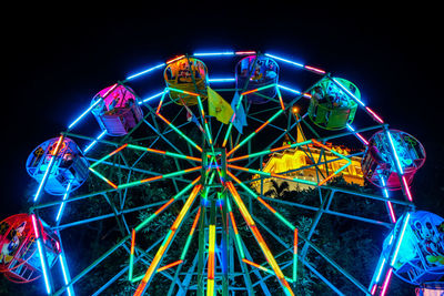 Low angle view of ferris wheel against sky at night