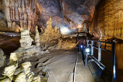 View of illuminated subway through cave