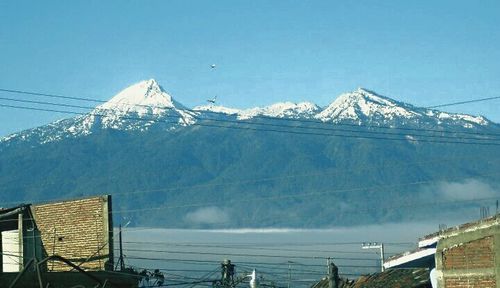 View of snow covered mountain against blue sky