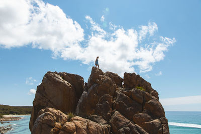 Rock formations by sea against sky