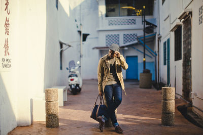 Rear view of woman walking on street in city
