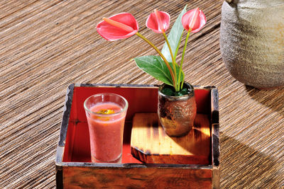 High angle view of smoothie with flowers on table