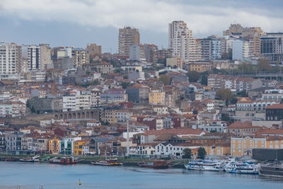 Aerial view of buildings in city against sky