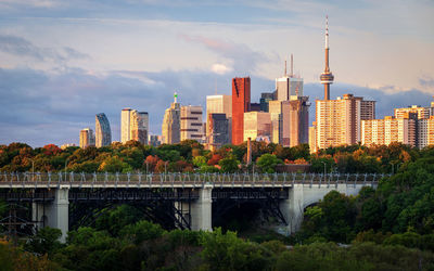 Arch bridge and buildings against sky in city