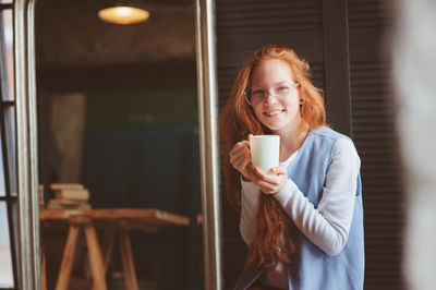 Portrait of a young woman drinking coffee cup