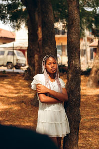Girl standing on tree trunk