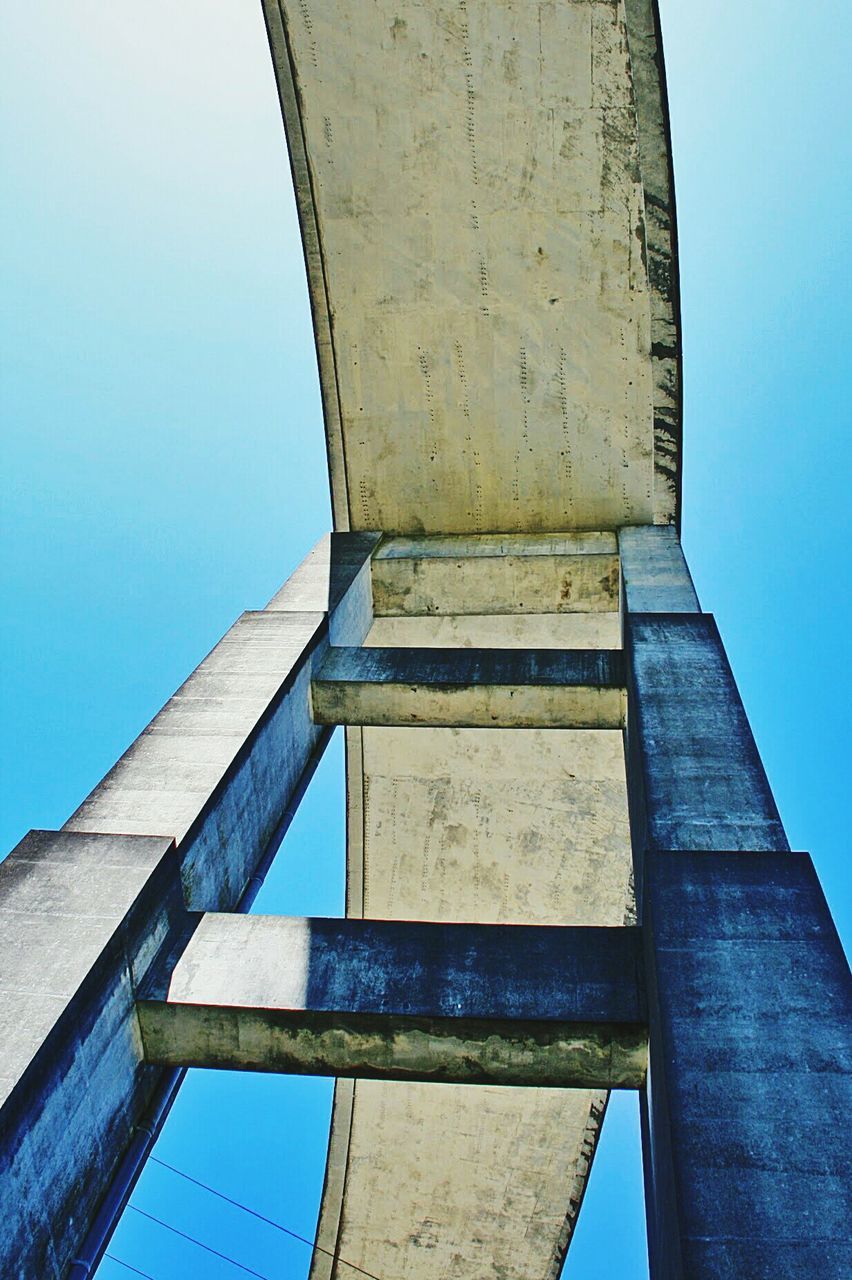 architecture, sky, low angle view, built structure, no people, day, clear sky, blue, nature, outdoors, tower, building exterior, connection, bridge, bridge - man made structure, architectural column, sunlight, wood - material, pattern, building, directly below, concrete