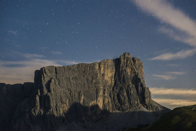 Panoramic view of rock formations against sky at night