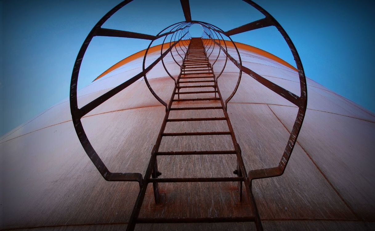 LOW ANGLE VIEW OF LADDER AGAINST BLUE SKY