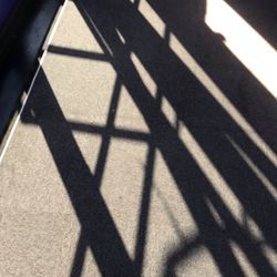 Shadow of railing on road