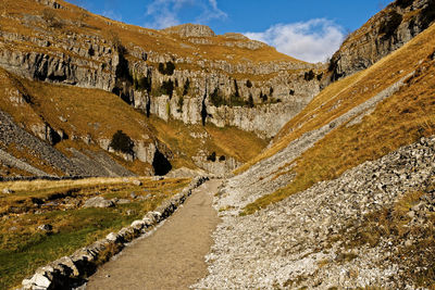 Panoramic view of road leading towards mountains against sky