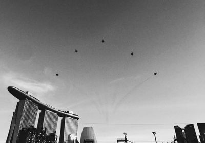 Low angle view of birds flying in sky