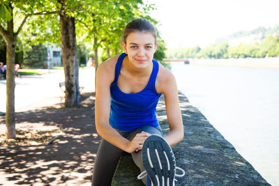 Portrait of young woman sitting outdoors