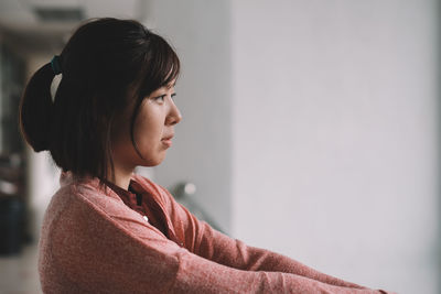 Side view of young woman