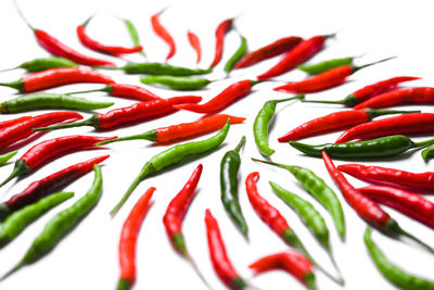 Close-up of red chili peppers against white background