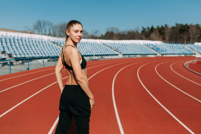 Portrait of woman standing on stadium