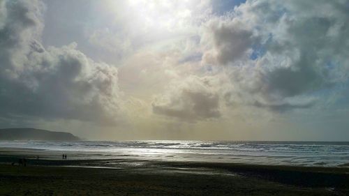 Scenic view of sea against cloudy sky