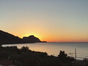 Scenic view of sea against clear sky during sunset