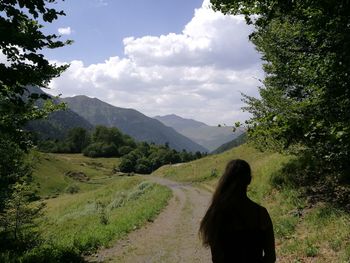 Rear view of man on landscape against sky