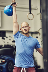 Man training in gym with kettlebell