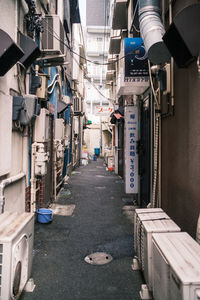 Empty road amidst buildings in city