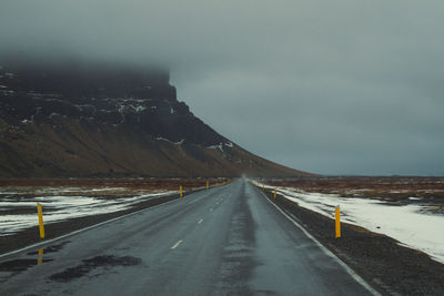 Highway across snowy field landscape photo