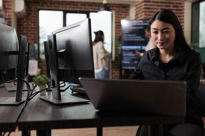 Portrait of woman using laptop on table