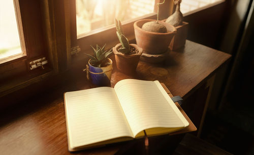 High angle view of open book on table at home