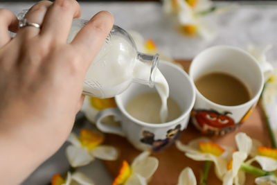 Cropped hand of woman having food