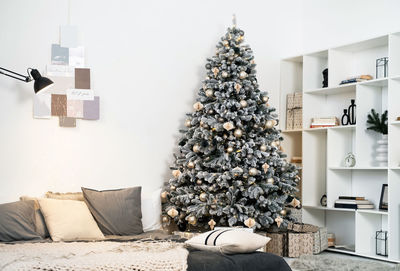 Cozy christmas tree at home surrounded with gifts christmas tree