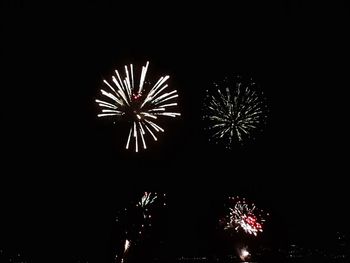 Low angle view of firework display at night