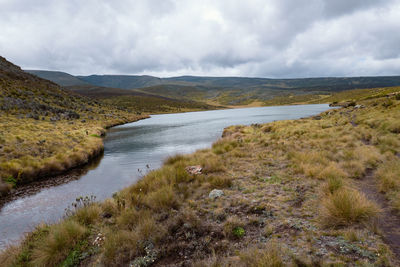 Scenic view of lake ellis against mountains at chogoria route, mount kenya national park, kenya