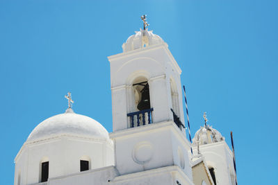 Low angle view of bell tower against clear blue sky