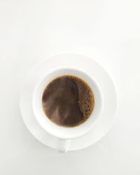 High angle view of coffee cup on white background