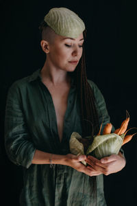 Creative portrait of vegan woman holding vegetables. veganism, vegetarianism, plant-based diet