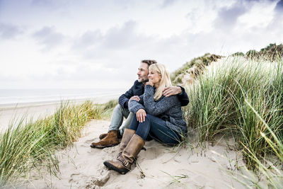 Couple sitting in dunes