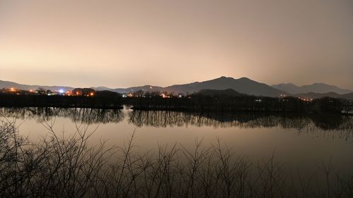 Scenic view of lake against sky during sunset