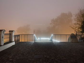 View of illuminated street against sky at night