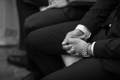 Midsection of man and woman sitting on floor