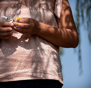 Midsection of woman holding hands