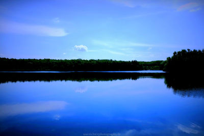 Scenic view of lake against blue sky