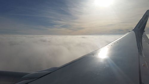 Close-up of airplane wing against sky