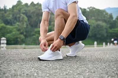 Low section of woman jogging on road