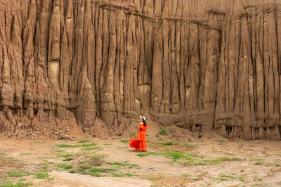 Women and landscape of soil textures eroded sandstone pillars, columns and cliffs, 