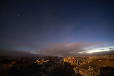 Scenic view of landscape against sky at night